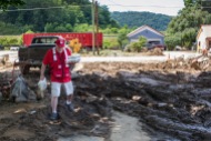 June 30, 2016. Birch River, West Virginia. American Red Cross worker Kevin Beale delivers containers of pulled pork to a Birch River, West Virginia, resident. The emergency response vehicle traveled through neighborhoods, delivering nearly 150 hot meals to the community. Photo by Marko Kokic for the American Red Cross