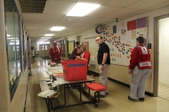 Red Cross shelter workers setting up a shelter for Cuyahoga Falls residents inside a local school building