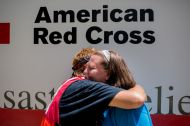 August 18, 2016. Denham Springs, Louisiana. During a hot meal distribution in southern Louisiana, Red Cross volunteer Cora Lee, a local relief worker from Baton Rouge, hugs her daughter Shannon Lee, whose home was flooded in Denham Springs. Photo by: Marko Kokic/American Red Cross